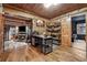 Spacious rustic office showcasing wood-paneled walls, hardwood floors, and open doorway views at 80 Rountree Rd, Riverdale, GA 30274