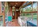 Bright sunroom with wood trim and a playful crib, offering a versatile and inviting living space at 80 Rountree Rd, Riverdale, GA 30274