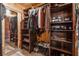 Spacious walk-in closet featuring built-in shelving, a full length mirror, and an abundance of clothing at 80 Rountree Rd, Riverdale, GA 30274