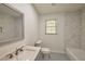 Bright bathroom featuring marble-patterned tile, granite vanity, and modern fixtures at 1332 Willis Mill Sw Rd, Atlanta, GA 30311