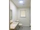 Bathroom featuring neutral paint, grey vanity, and a window for natural light at 1332 Willis Mill Sw Rd, Atlanta, GA 30311