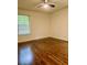 Bedroom with hardwood floors, neutral colored walls, and natural light from a window at 1332 Willis Mill Sw Rd, Atlanta, GA 30311