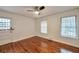 Inviting bedroom features beautiful hardwood floors, a ceiling fan, and natural light from updated windows at 1332 Willis Mill Sw Rd, Atlanta, GA 30311