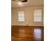 Bedroom with hardwood floors, two windows, and overhead lighting at 1332 Willis Mill Sw Rd, Atlanta, GA 30311