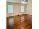 This bright bedroom offers gleaming hardwood floors and multiple windows for natural light at 1332 Willis Mill Sw Rd, Atlanta, GA 30311