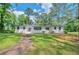 Charming one-story home with a well-manicured lawn and inviting walkway, surrounded by mature trees at 1332 Willis Mill Sw Rd, Atlanta, GA 30311
