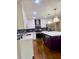 Modern kitchen featuring white cabinets, a dark backsplash, stainless appliances, and island at 1332 Willis Mill Sw Rd, Atlanta, GA 30311