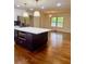 Kitchen island with microwave and dark cabinets with a view of the dining room at 1332 Willis Mill Sw Rd, Atlanta, GA 30311