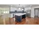 Beautiful kitchen featuring an island with white countertops, stainless steel appliances, and modern lighting at 1332 Willis Mill Sw Rd, Atlanta, GA 30311