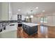 Bright open kitchen with island, modern appliances, stylish backsplash, hardwood floors, and recessed lighting at 1332 Willis Mill Sw Rd, Atlanta, GA 30311