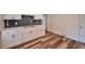 This kitchenette features new white cabinets, modern hardware, black subway tile, and stylish vinyl plank flooring at 1332 Willis Mill Sw Rd, Atlanta, GA 30311