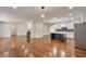 Spacious living room with a fireplace, open to a modern kitchen and features hardwood floors throughout at 1332 Willis Mill Sw Rd, Atlanta, GA 30311