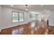 Living room featuring hardwood floors, a fireplace, large windows, and open space for comfortable living at 1332 Willis Mill Sw Rd, Atlanta, GA 30311