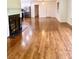 Living room showcasing hardwood floors, fireplace, and access to the kitchen and hallway at 1332 Willis Mill Sw Rd, Atlanta, GA 30311