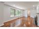 Living room featuring hardwood floors, a fireplace, large windows, and open space for comfortable living at 1332 Willis Mill Sw Rd, Atlanta, GA 30311