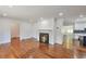 Open living room featuring a fireplace and hardwood floors leading to a modern kitchen and large windows at 1332 Willis Mill Sw Rd, Atlanta, GA 30311