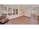 Bright, sunlit screened porch with brick walls, new laminate floors and a comfortable chair at 1332 Willis Mill Sw Rd, Atlanta, GA 30311