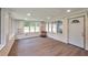 A sun-drenched screened porch with new laminate floors, brick walls and lots of natural light at 1332 Willis Mill Sw Rd, Atlanta, GA 30311