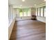 Bright sunroom with large windows, white brick walls, and wood-style flooring at 1332 Willis Mill Sw Rd, Atlanta, GA 30311