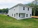 A lush green backyard with a well-maintained lawn, showcasing the home's outdoor space and vinyl siding at 145 Scarlett Place Dr, Bowdon, GA 30108