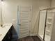 Bathroom featuring a single sink vanity, dark wood cabinets, quartz countertops, and a glass enclosed shower at 145 Scarlett Place Dr, Bowdon, GA 30108