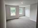 Sunlit bedroom featuring large windows, plush carpeting, and neutral paint for a calming retreat at 145 Scarlett Place Dr, Bowdon, GA 30108