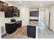 Modern kitchen featuring granite countertops, stainless steel appliances, and dark wood cabinets at 145 Scarlett Place Dr, Bowdon, GA 30108