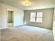 Spacious carpeted bedroom featuring a bright window with natural light at 3275 Wild Basil Ln, Buford, GA 30519