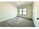 Bedroom features plush carpet and a large window at 3275 Wild Basil Ln, Buford, GA 30519