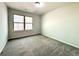 Bedroom with plush carpet and a large window at 3275 Wild Basil Ln, Buford, GA 30519