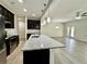 Stylish kitchen with stainless steel appliances, dark wood cabinets, and granite countertops with living space views at 3275 Wild Basil Ln, Buford, GA 30519