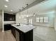 Bright and airy kitchen flows into the living area with large windows and modern fixtures at 3275 Wild Basil Ln, Buford, GA 30519