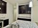 Modern kitchen features granite countertops, dark cabinets, and stainless steel appliances at 3275 Wild Basil Ln, Buford, GA 30519