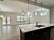 Open concept kitchen featuring a large island with granite countertops and views of the outdoor space at 3275 Wild Basil Ln, Buford, GA 30519