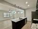 Open concept kitchen features granite countertops, stainless appliances, and a view of the living area at 3275 Wild Basil Ln, Buford, GA 30519
