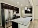 Modern kitchen featuring stainless steel appliances, granite countertops, and ample storage space at 3275 Wild Basil Ln, Buford, GA 30519