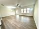 Large living room with laminate floors, natural light, and neutral walls at 3275 Wild Basil Ln, Buford, GA 30519