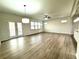 Inviting living room featuring ample windows and natural light flowing from the doors at 3275 Wild Basil Ln, Buford, GA 30519