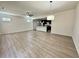 Open-concept living space with modern lighting and expansive luxury vinyl flooring at 3275 Wild Basil Ln, Buford, GA 30519