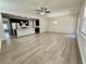 Spacious living room with sleek flooring and abundant natural light flowing into the kitchen at 3275 Wild Basil Ln, Buford, GA 30519