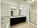 Bathroom featuring a double vanity with granite counters, a large mirror, a tub, and a glass enclosed shower at 3275 Wild Basil Ln, Buford, GA 30519
