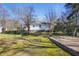 Backyard featuring mature trees and lawn, including swing set and deck, ready for Gathering enjoyment at 5812 Dogwood Cir, Austell, GA 30168