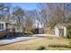 Expansive backyard with outbuildings and mature trees, offering a private and serene setting at 5812 Dogwood Cir, Austell, GA 30168