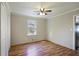 Bright bedroom featuring hardwood floors, neutral walls, ceiling fan, and closet storage space at 5812 Dogwood Cir, Austell, GA 30168