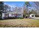 Quaint home with red front door, black shutters, and a detached garage accessible by a ramp at 5812 Dogwood Cir, Austell, GA 30168