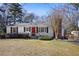 Charming single-story home with a red front door, black shutters, and landscaped front yard at 5812 Dogwood Cir, Austell, GA 30168