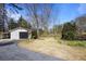 Charming home featuring a well-maintained front yard and a detached garage with a black door at 5812 Dogwood Cir, Austell, GA 30168