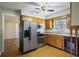 Spacious kitchen with stainless steel appliances, wood cabinets, and laminate flooring at 5812 Dogwood Cir, Austell, GA 30168