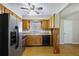 Well-lit kitchen with stainless steel appliances, wood cabinets, and a view into the adjoining living space at 5812 Dogwood Cir, Austell, GA 30168