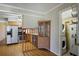 Inviting kitchen with stainless steel appliances and hardwood floors seamlessly connected to the laundry area at 5812 Dogwood Cir, Austell, GA 30168